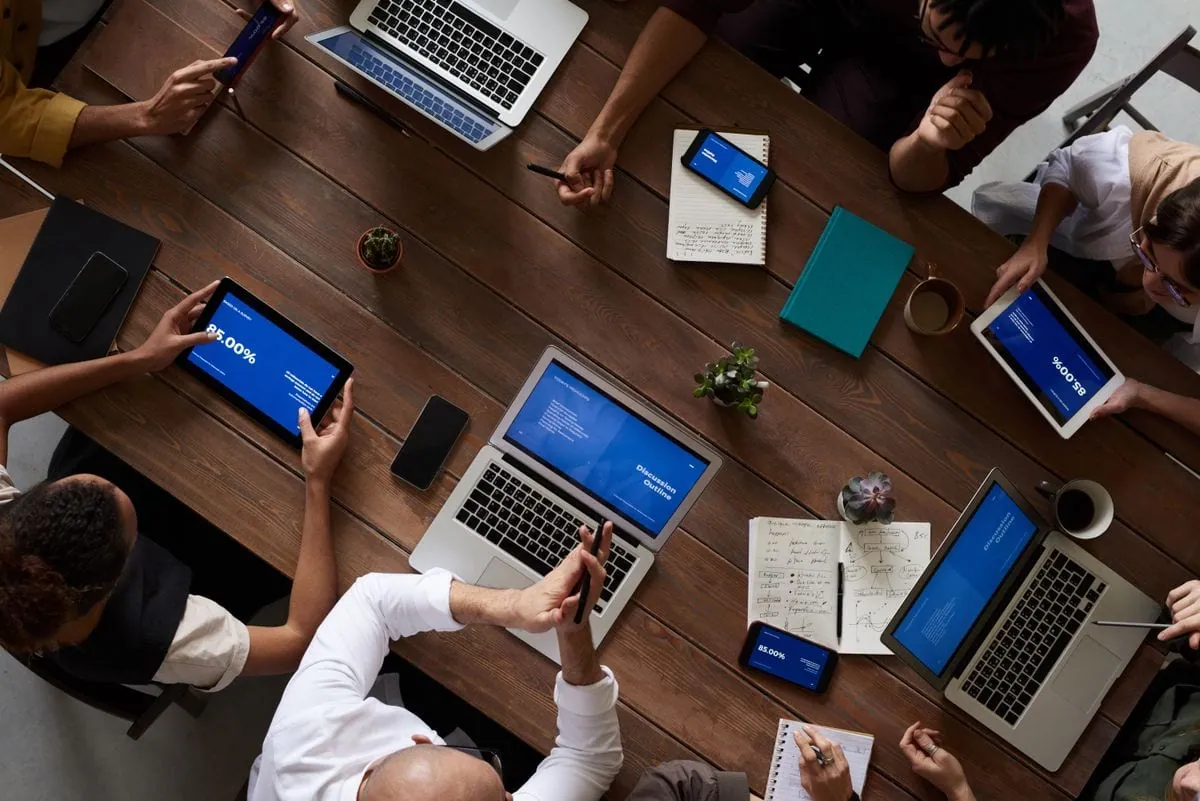 A team of professionals collaborating over laptops and dashboards
